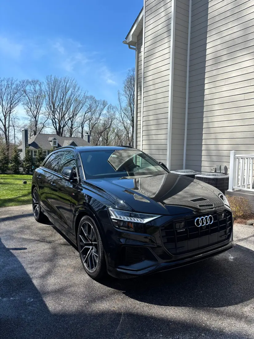 Black SUV with a mirror-like finish after a hand wash