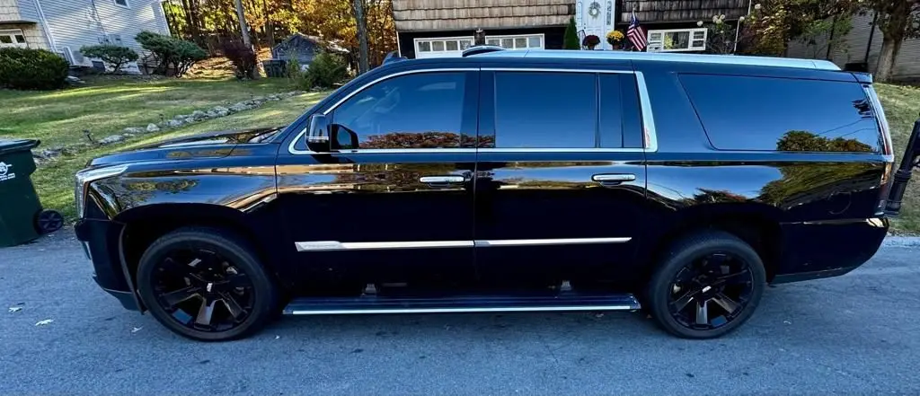 Black Cadillac Escalade with a deep gloss finish after an exterior detail