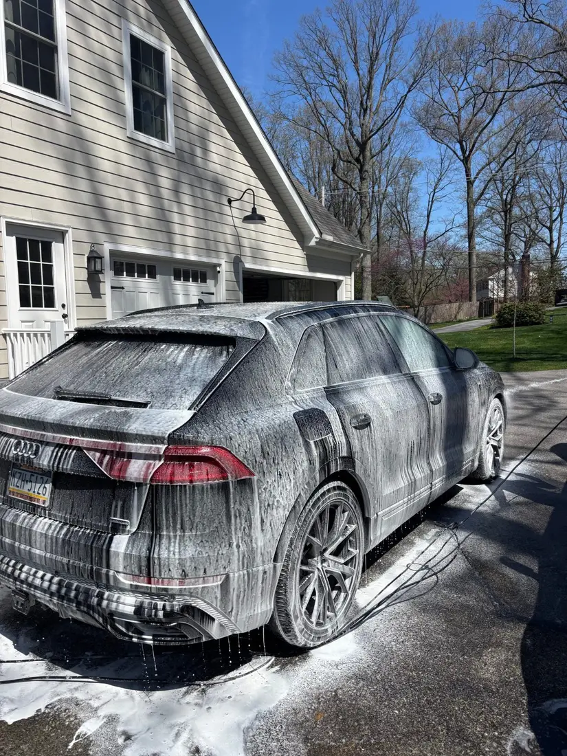 SUV covered in foam during a hand wash
